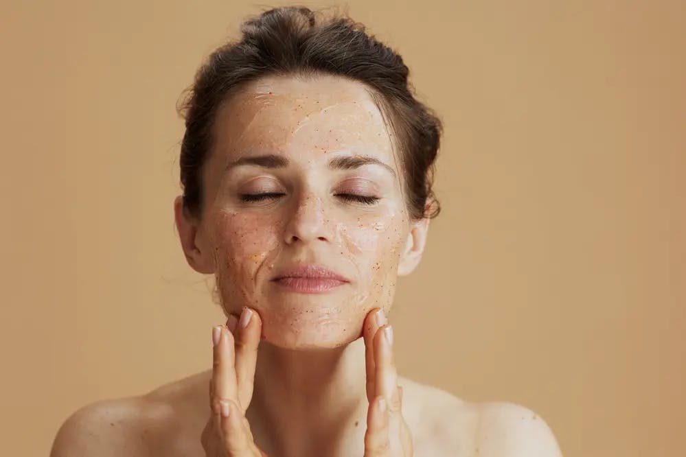 Cover Image for A woman rubbing a facial scrub into her skin
